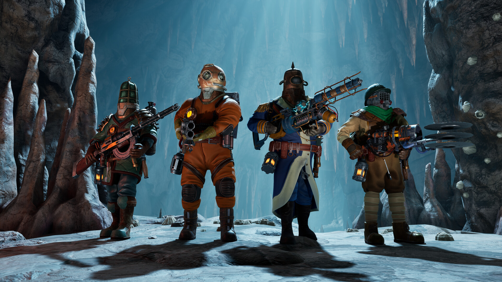 Four divers stand together inside a blue-lit cavern.