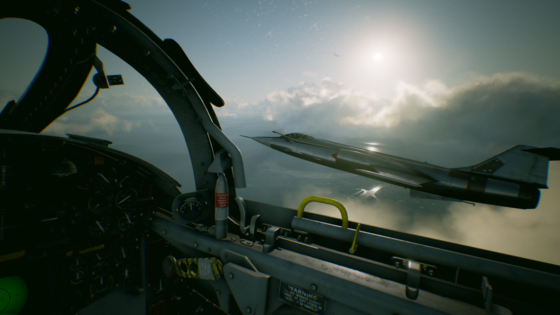 A fighter jet flies alongside another aircraft above the clouds.