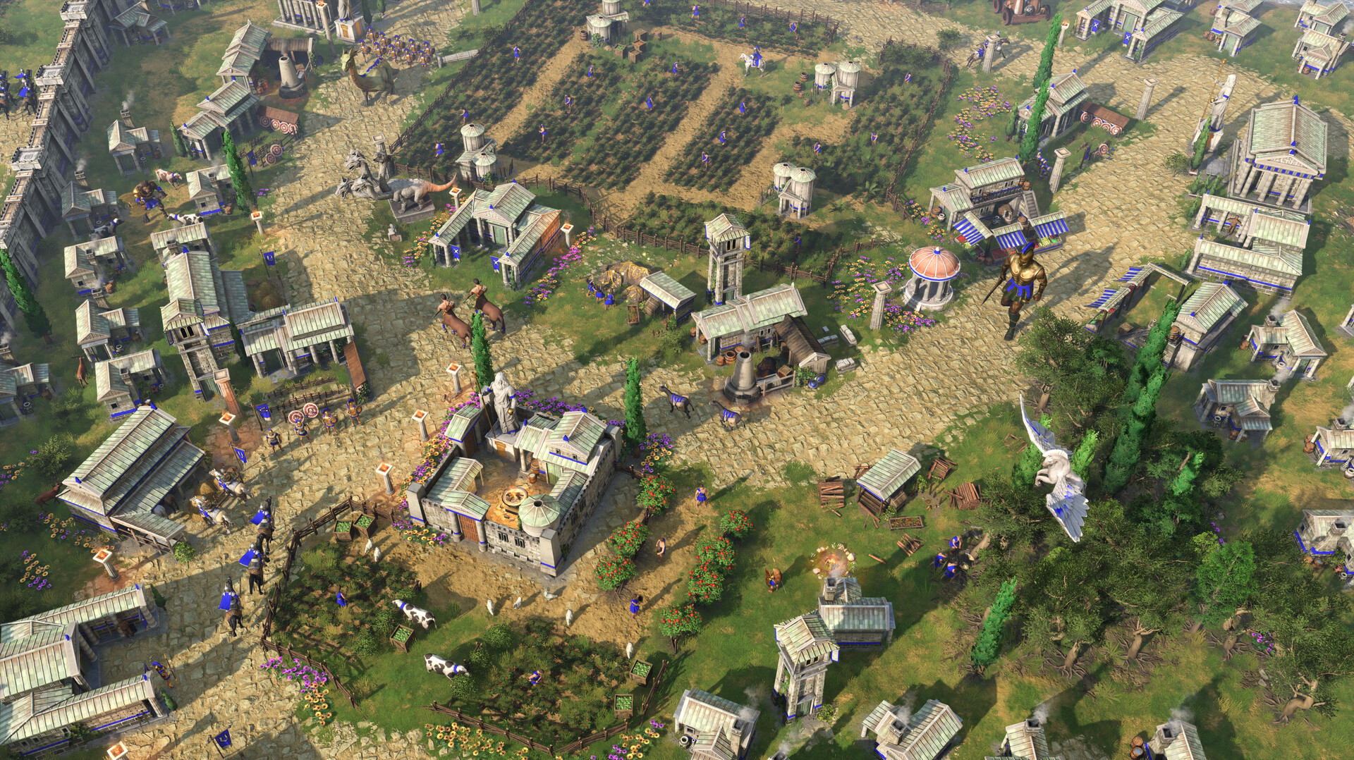 Units move through a settlement of stone buildings.