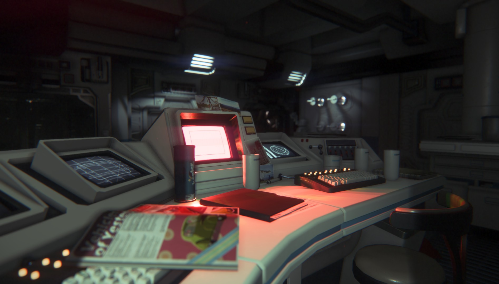 Amanda holds a motion tracker beside a lit workstation.