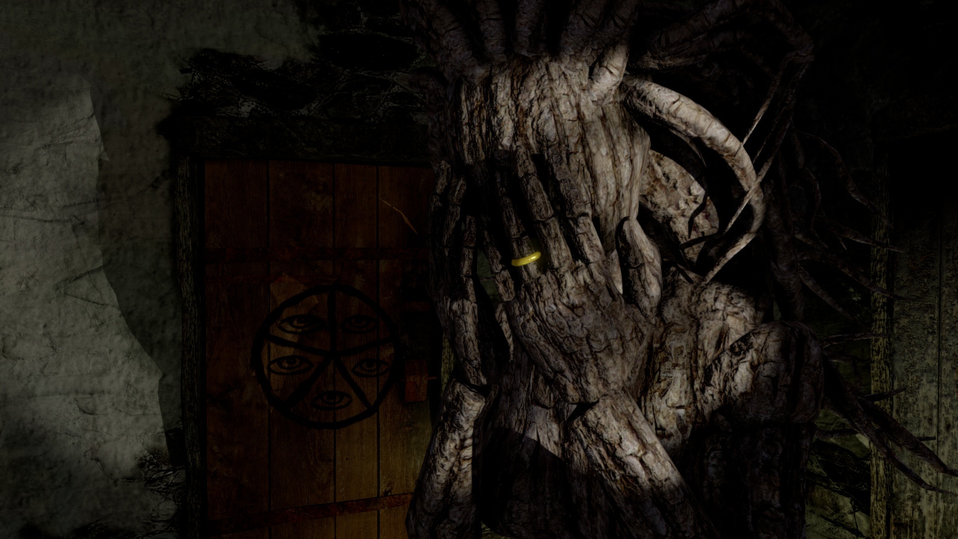 A door is overgrown by thick roots inside the mill.