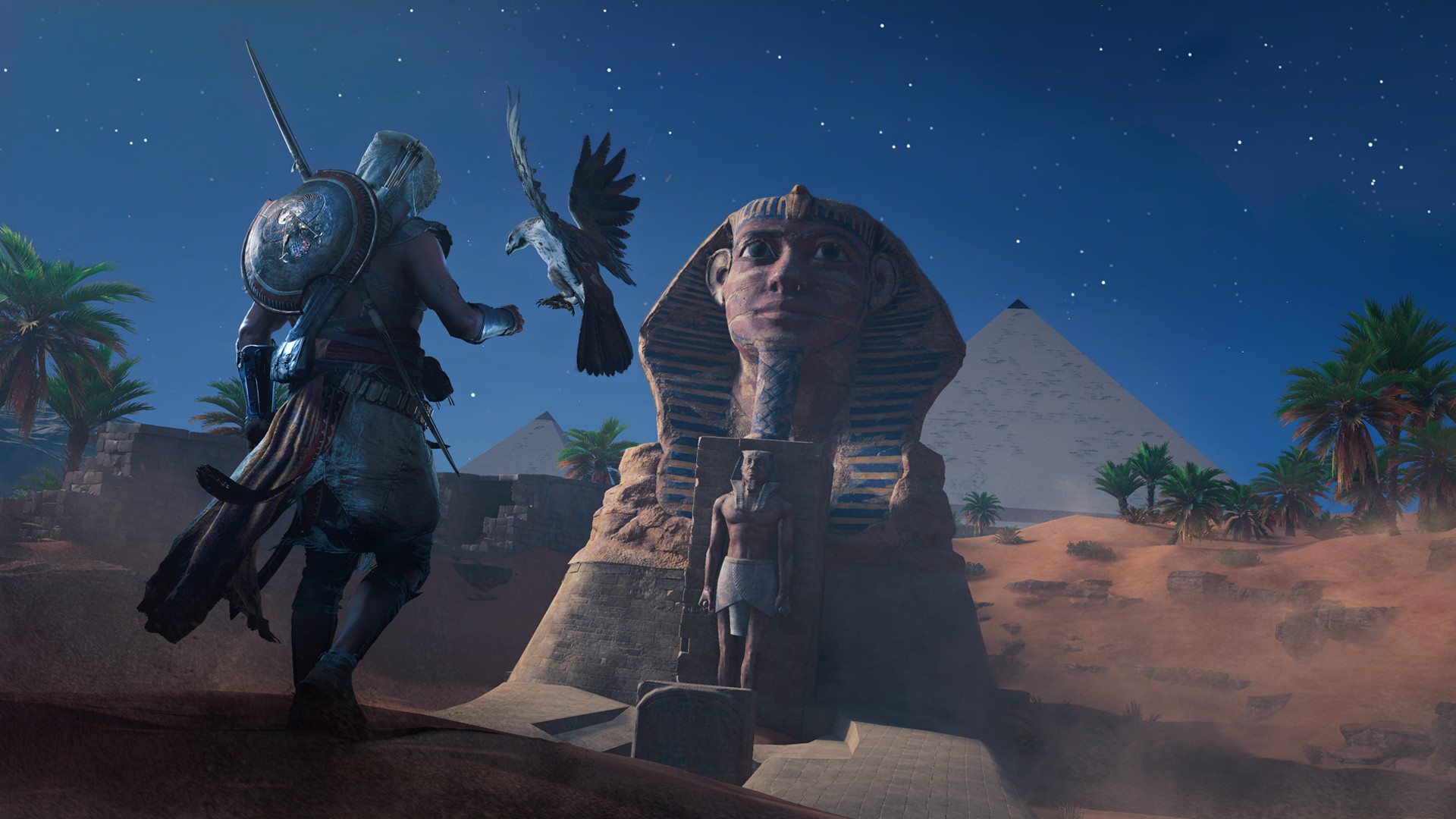 Bayek and his eagle overlook the Sphinx and pyramids at night.