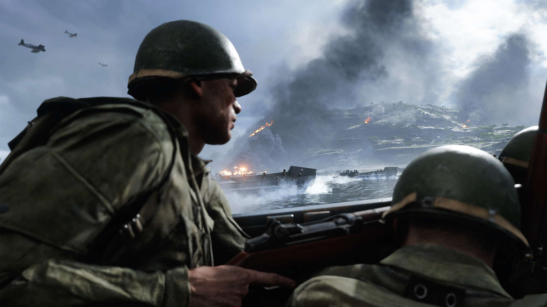 Soldiers approach a shoreline beneath aircraft and smoke.