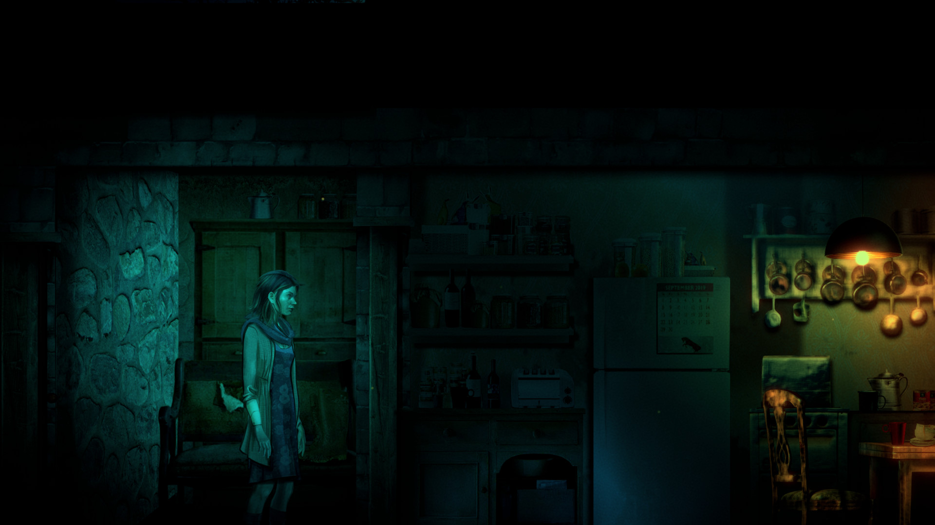 Angie stands in a dim kitchen lit by a lamp.