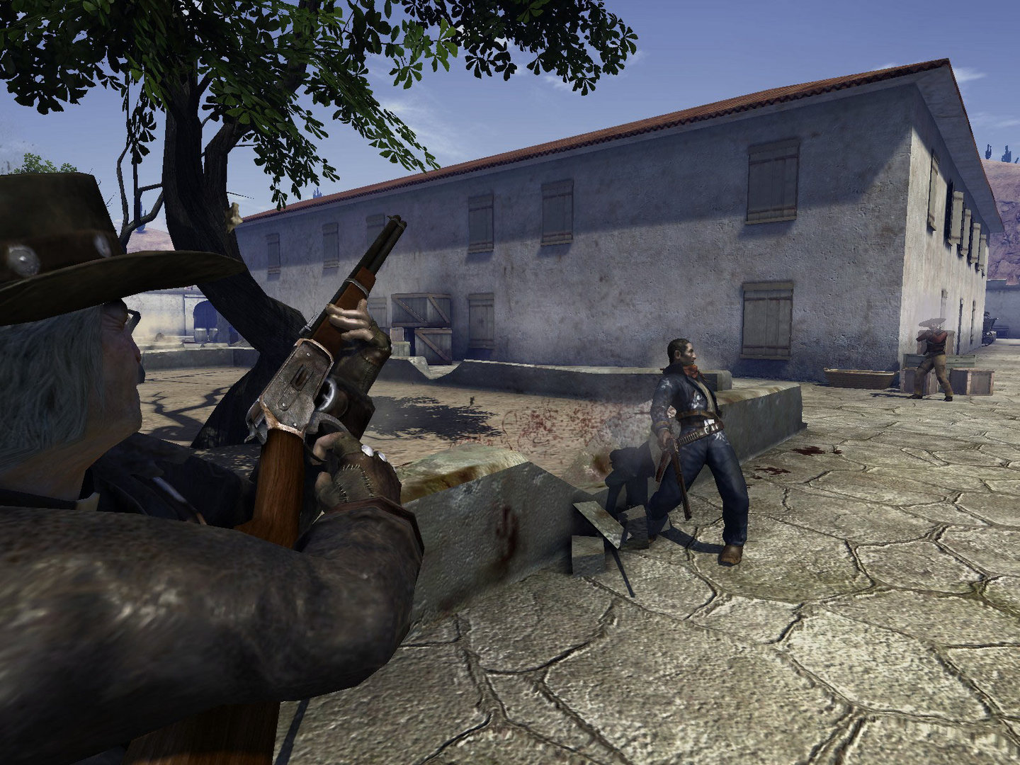A gunfighter aims toward an opponent beside a whitewashed building.