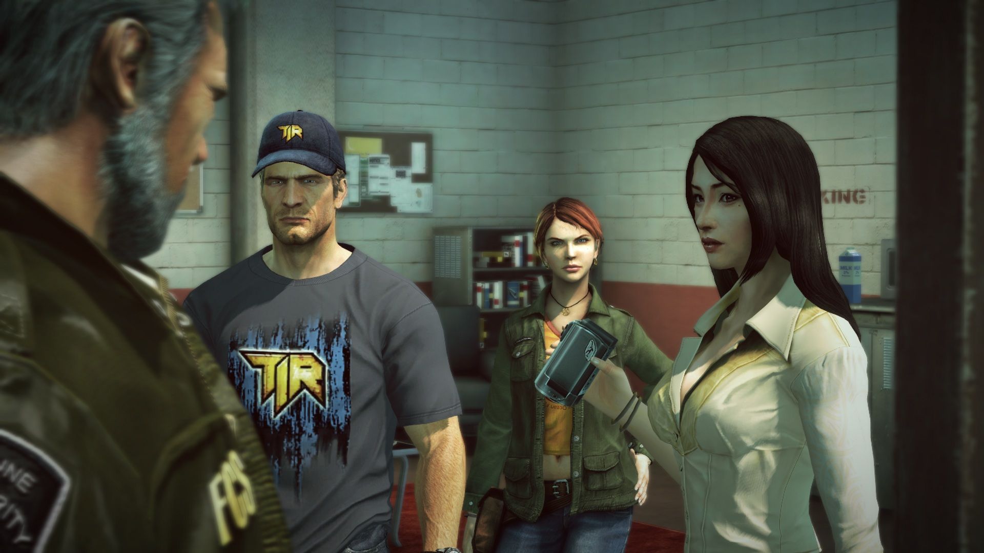 Chuck Greene speaks with other survivors in a room.
