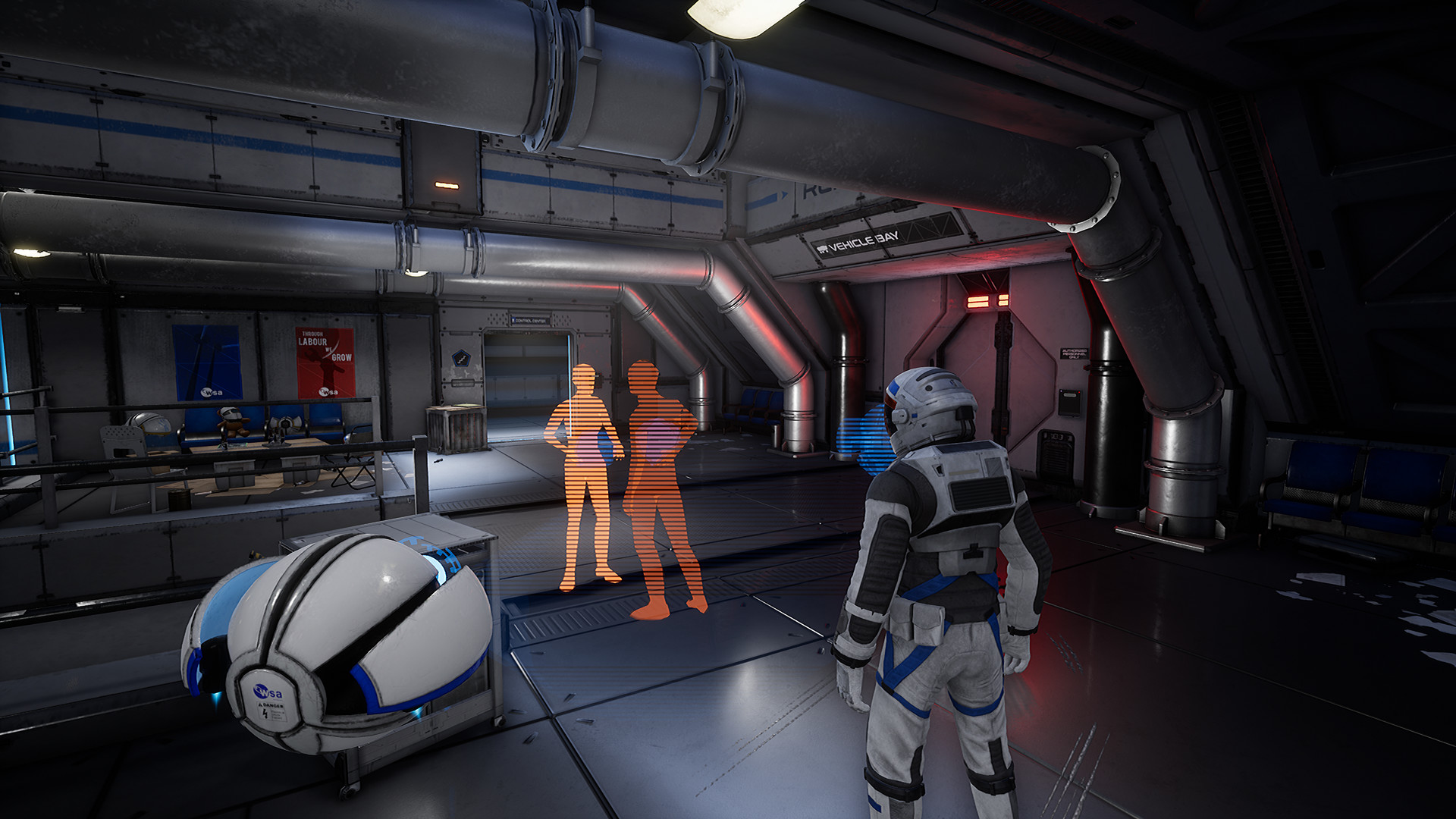An astronaut and mobile robot face holographic figures in a station room.
