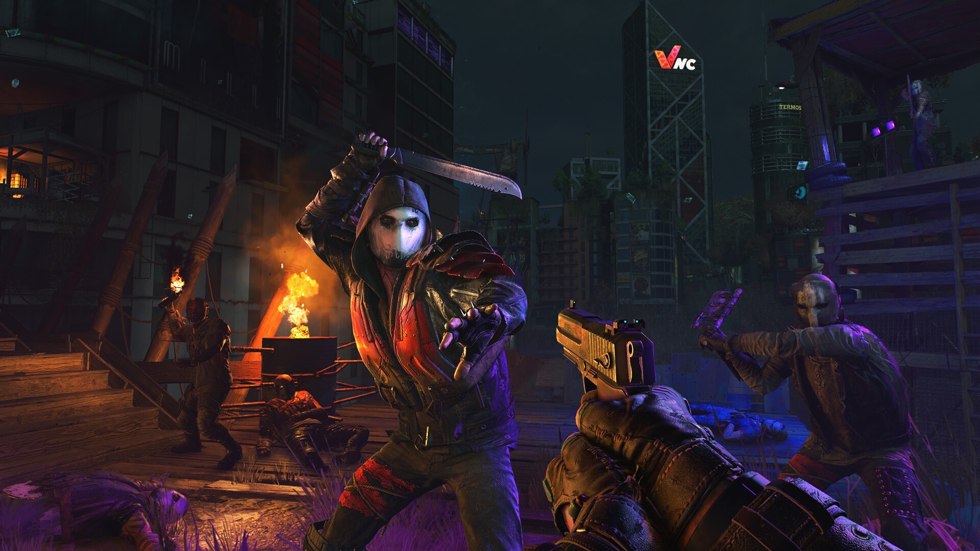 A survivor faces masked attackers on a burning city street at night.