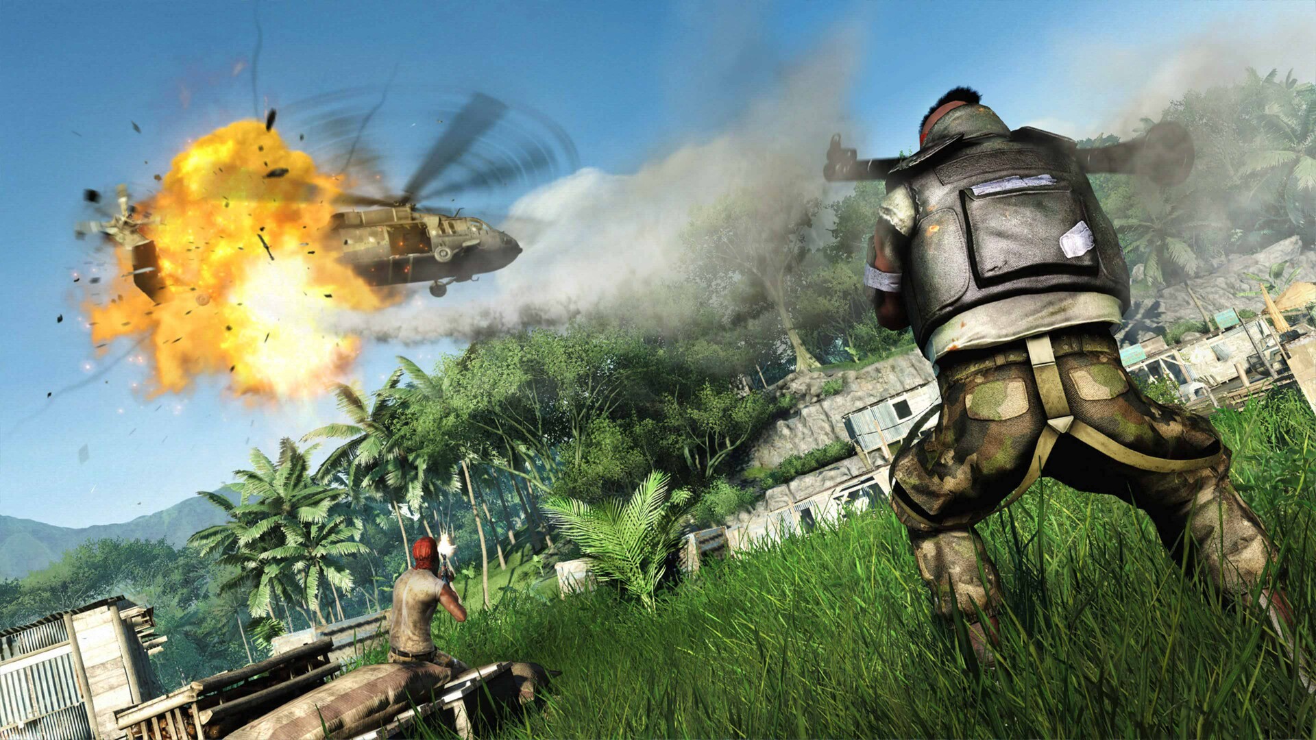A helicopter explodes above a tropical compound.