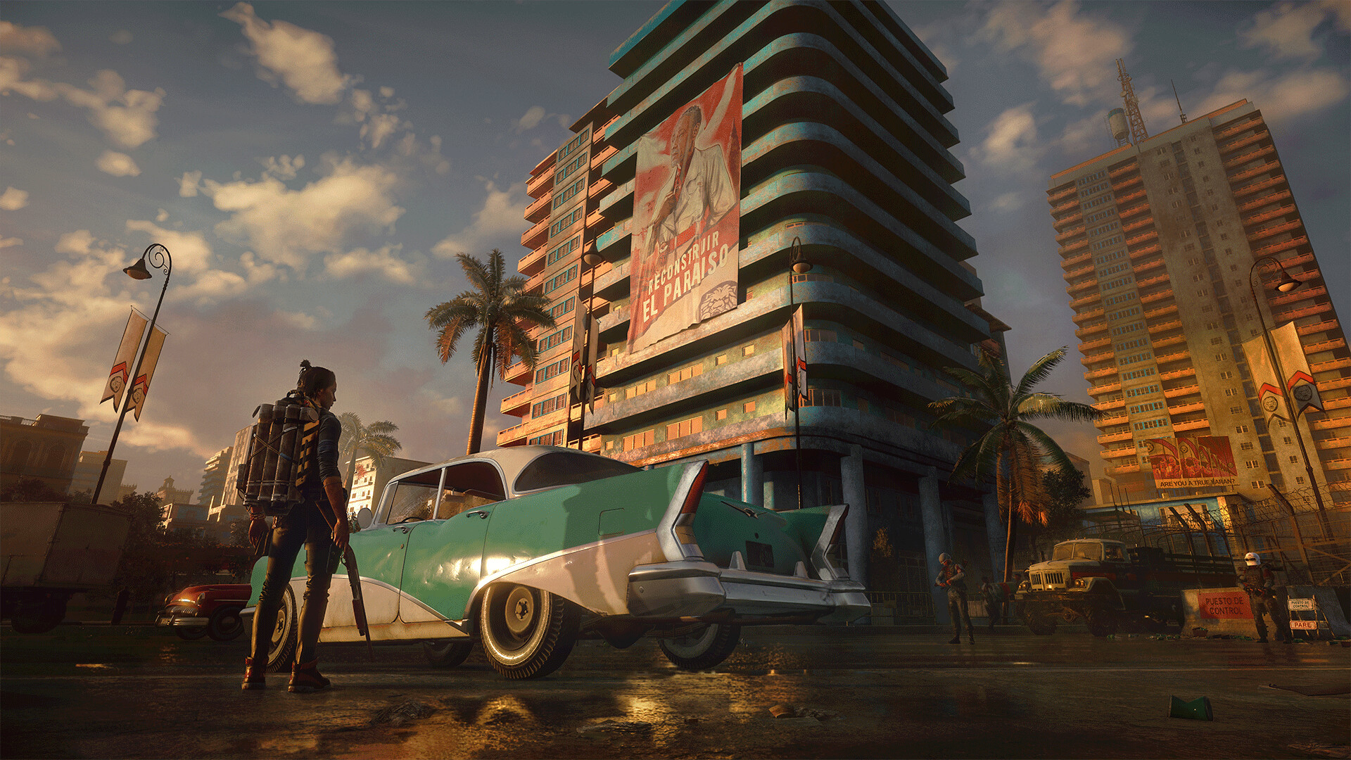 A fighter stands beside a car beneath a large urban billboard.