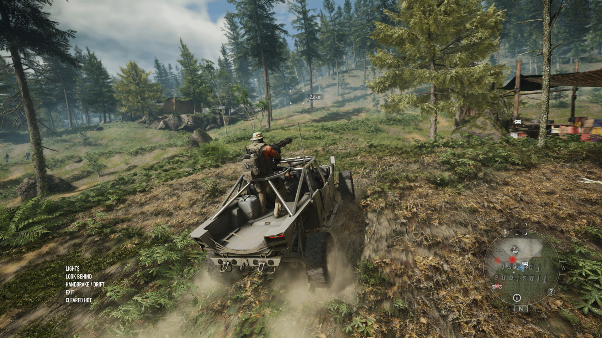 A light vehicle drives across the wooded terrain of Auroa.