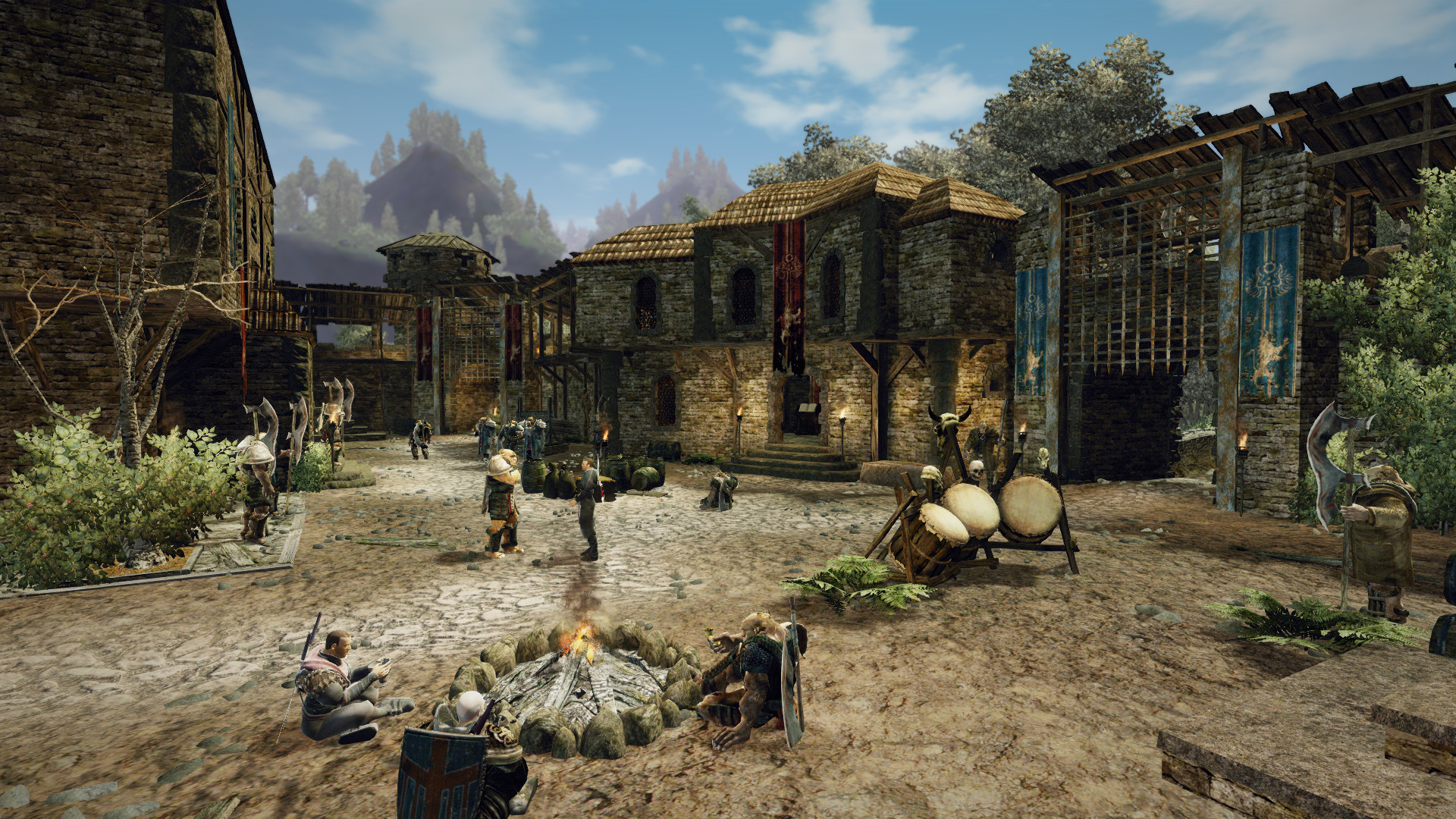 People gather around a fire in a stone-built settlement.