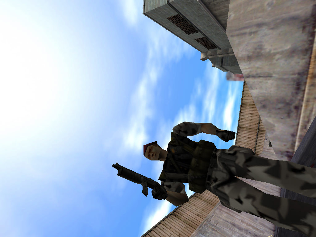 An armed soldier stands above Gordon beneath an open sky.