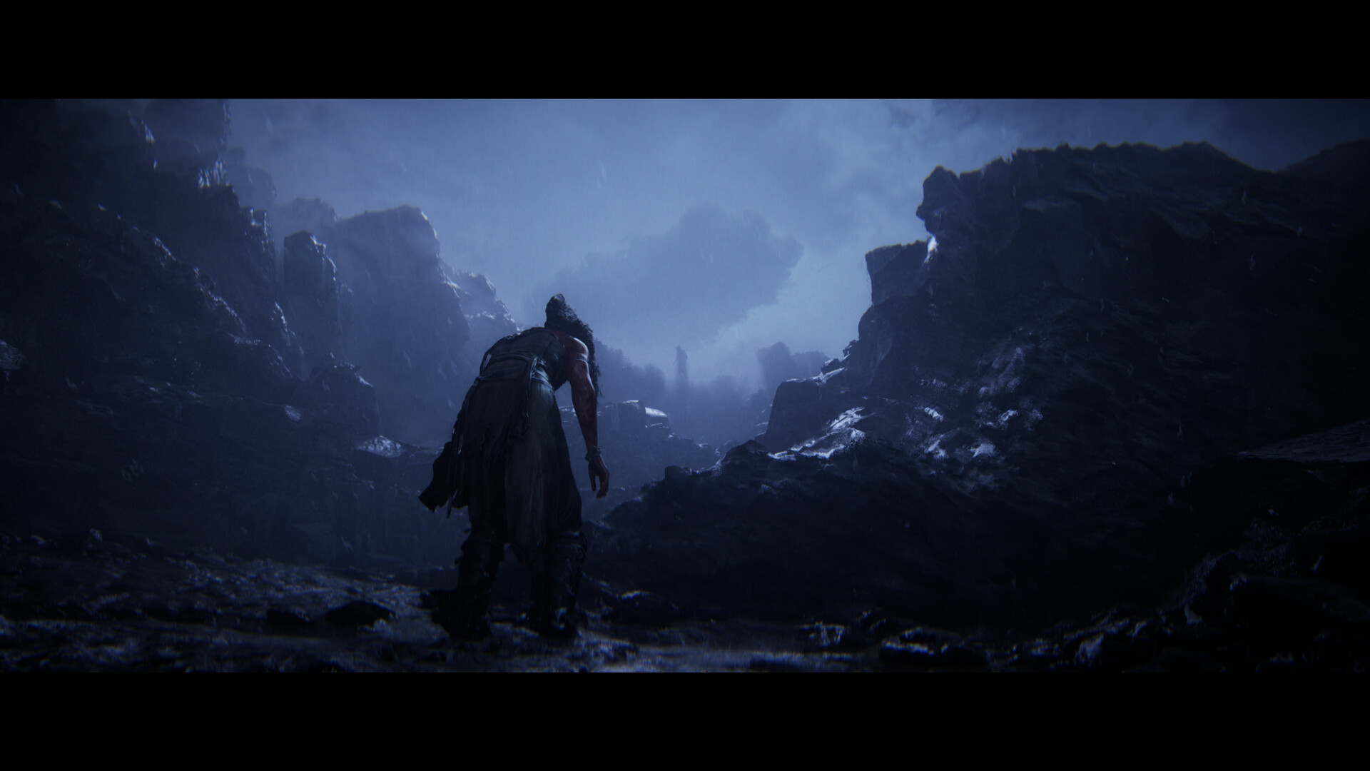 Senua crosses a dark rocky landscape in Iceland.
