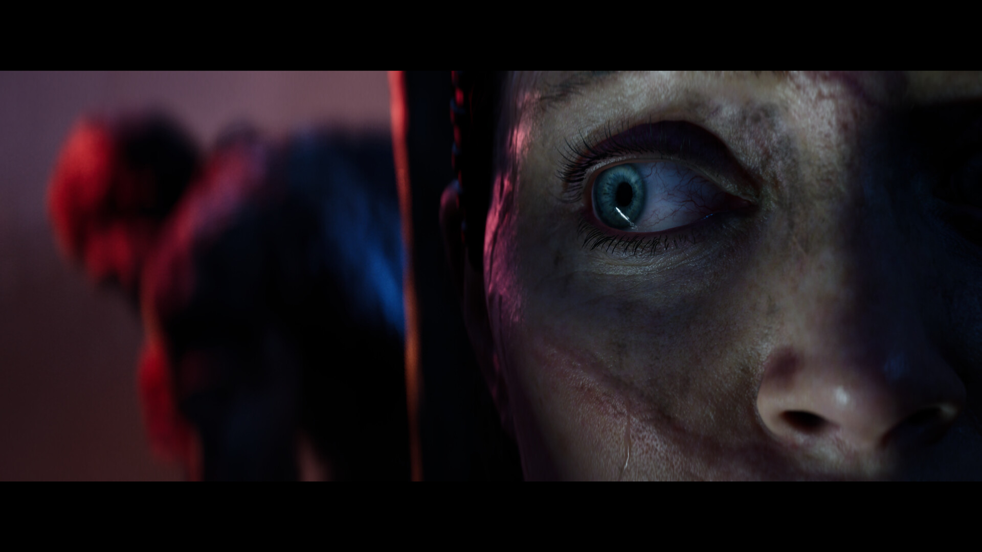 A close view of Senua’s face catches her watchful expression.