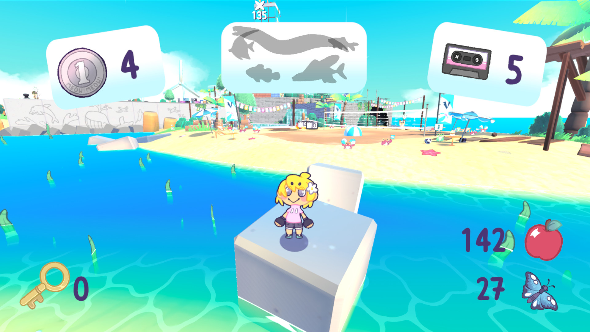 Niko stands on a raised block above an island beach and bright blue water.