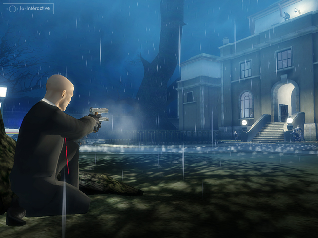 Agent 47 fires toward a guarded building in the rain.