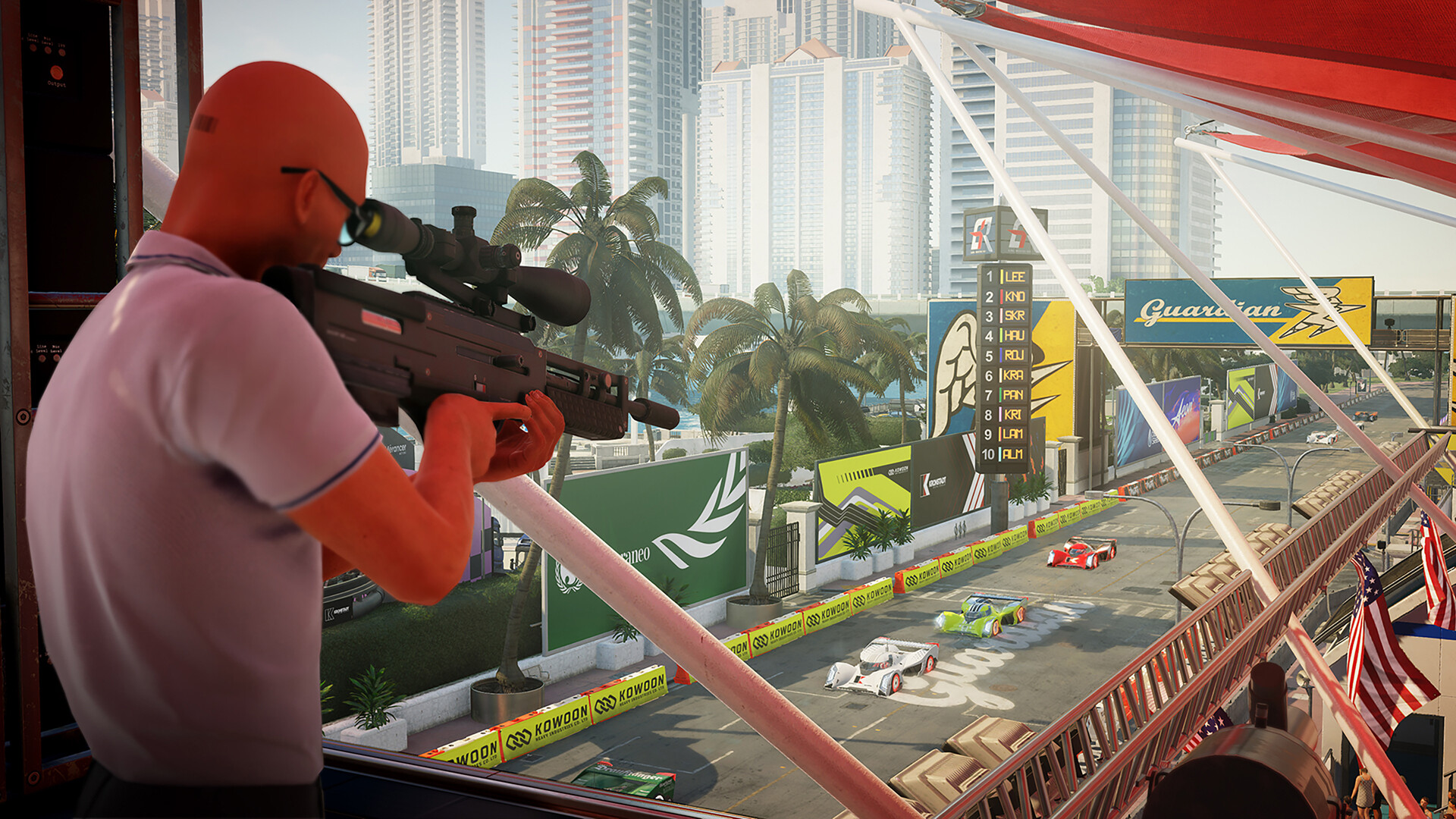 Agent 47 aims a rifle above a motor-racing circuit.