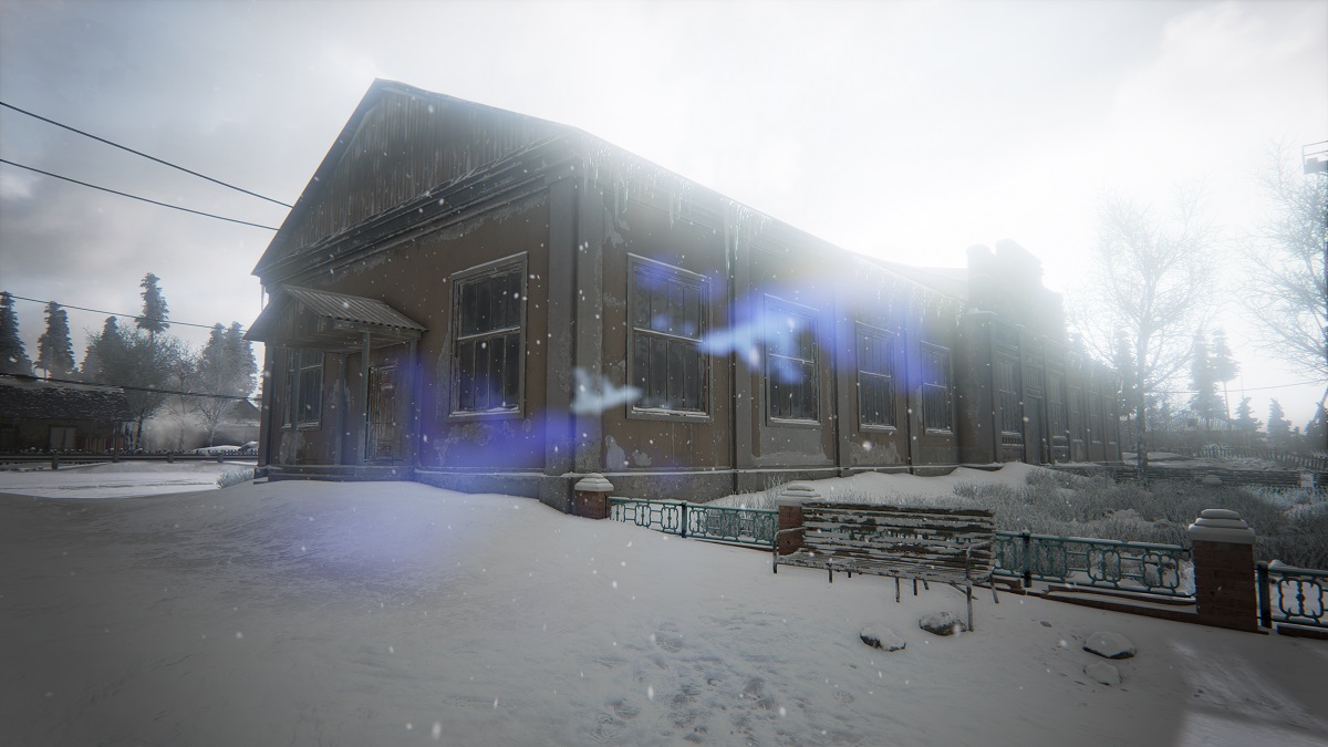 A snowy building lies beneath strong daylight.