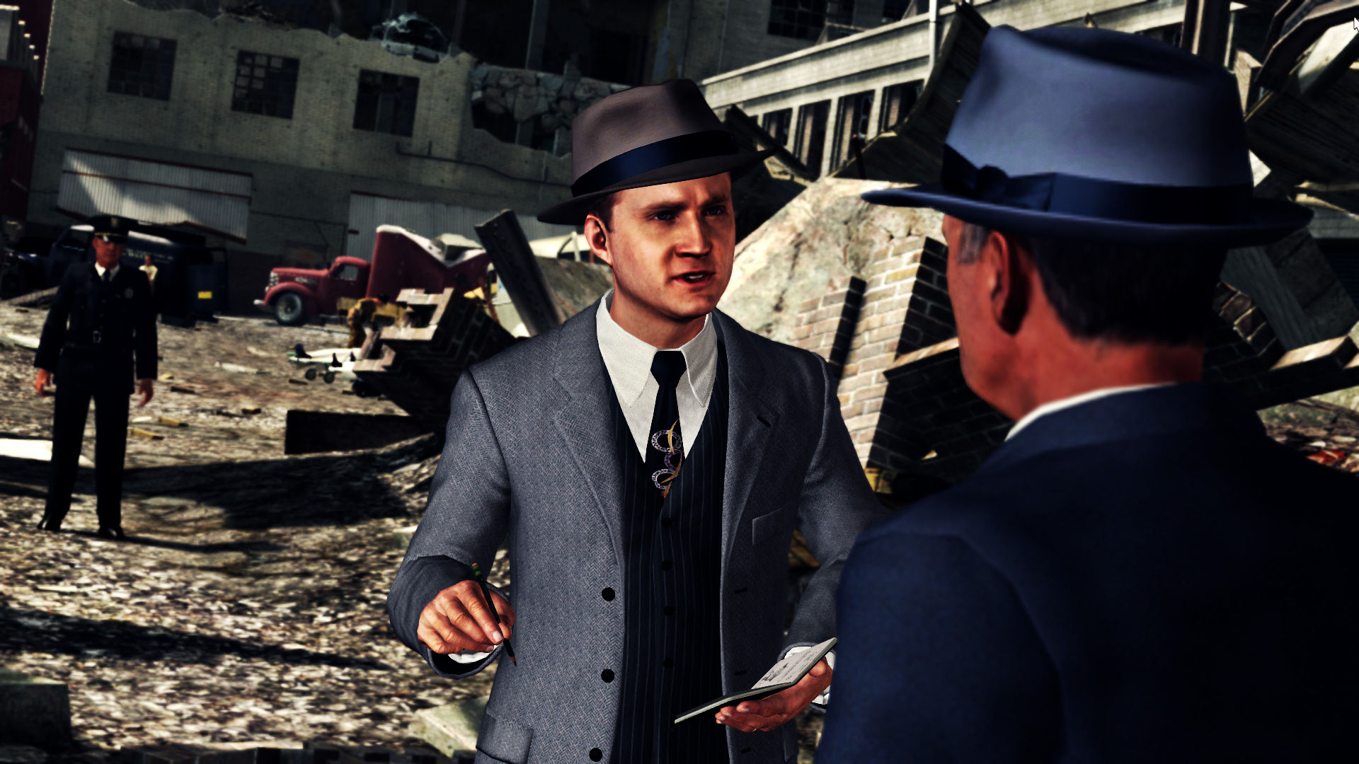 Cole Phelps speaks with another man near a city street.