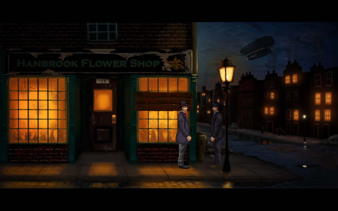 Miles Fordham speaks to a man outside a flower shop at night.