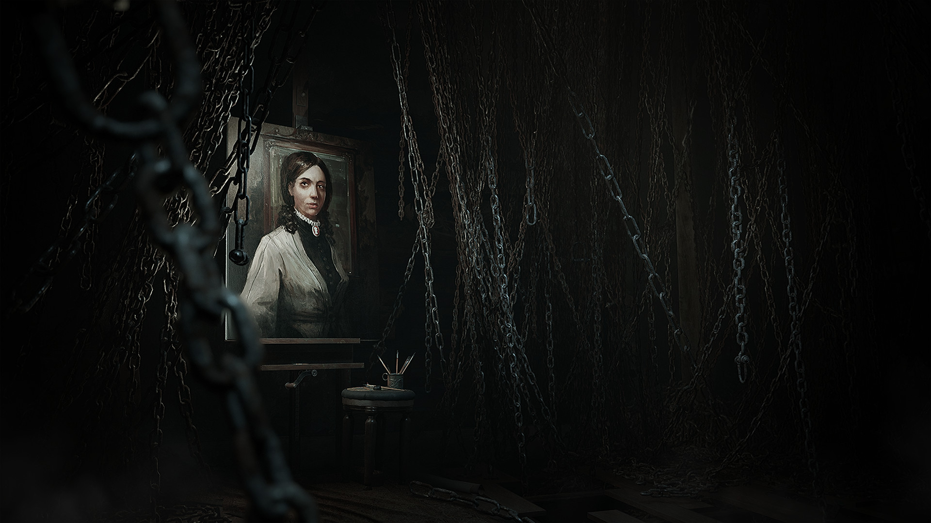 A woman stands beside a framed portrait in a dark room.