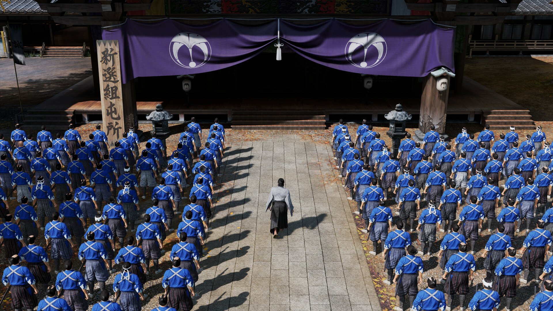 Rows of blue-uniformed soldiers stand outside a Japanese building.