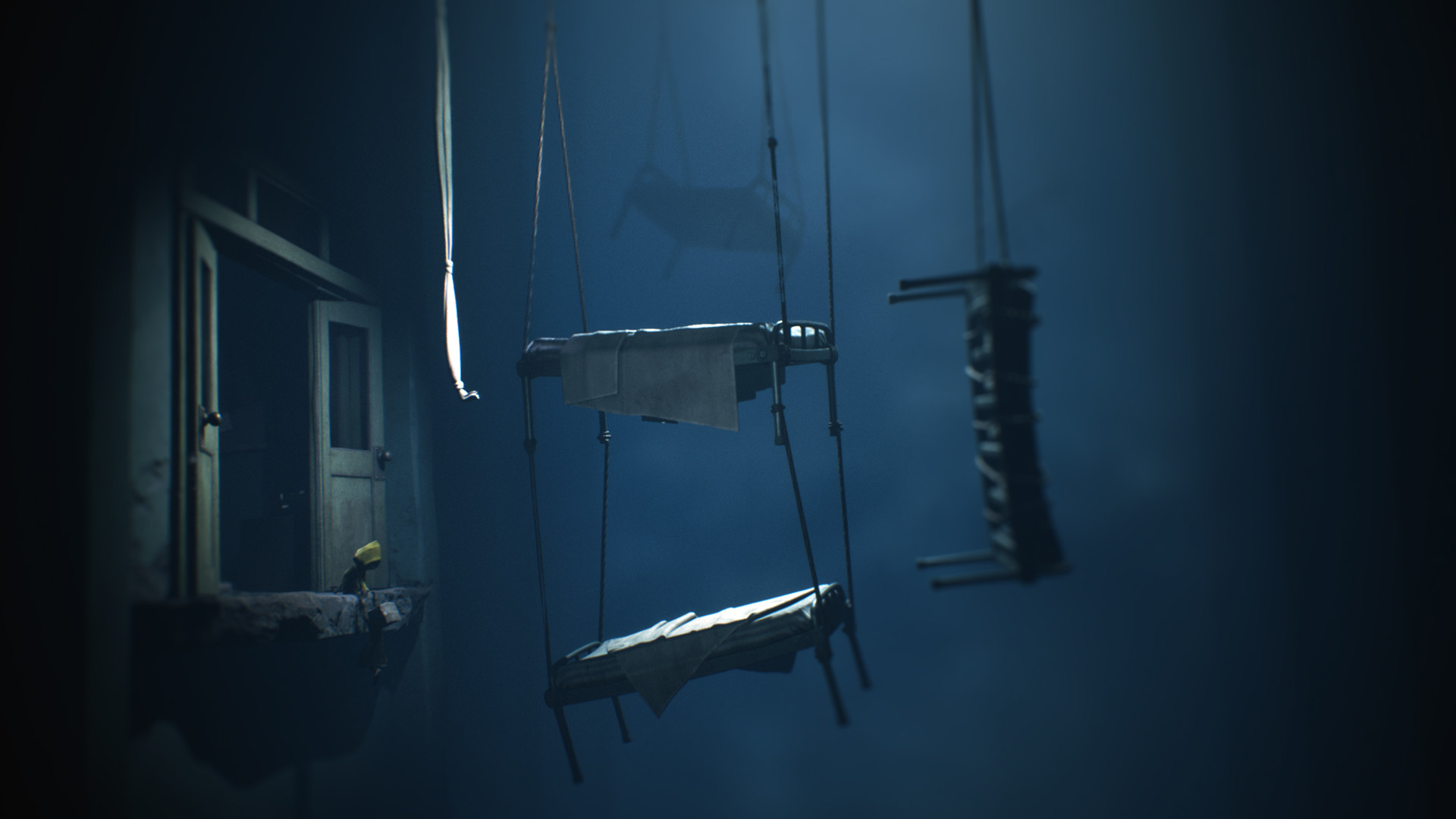 A small figure stands at a doorway beside a suspended bed.