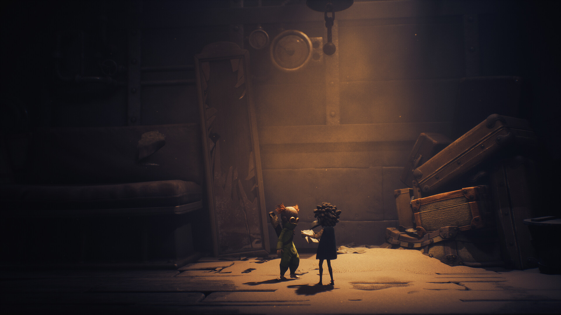 Two small figures stand beside a large mechanical structure.