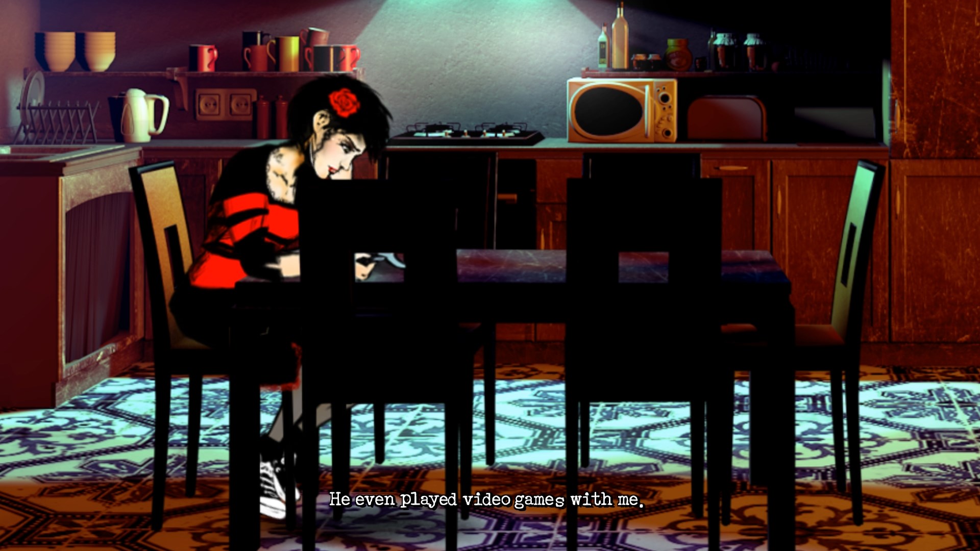 Lorelai sits at a kitchen table using a laptop.