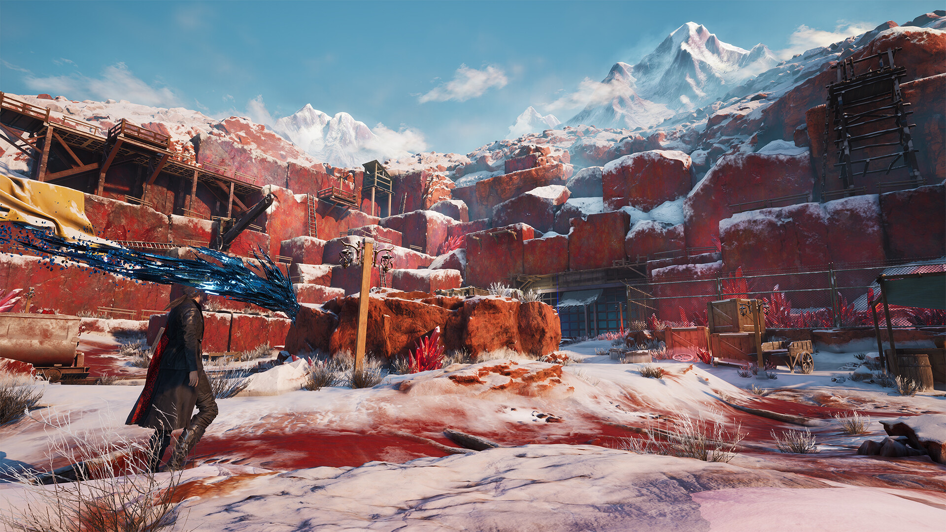 Kaser surveys a snowy settlement among red cliffs and high mountains.