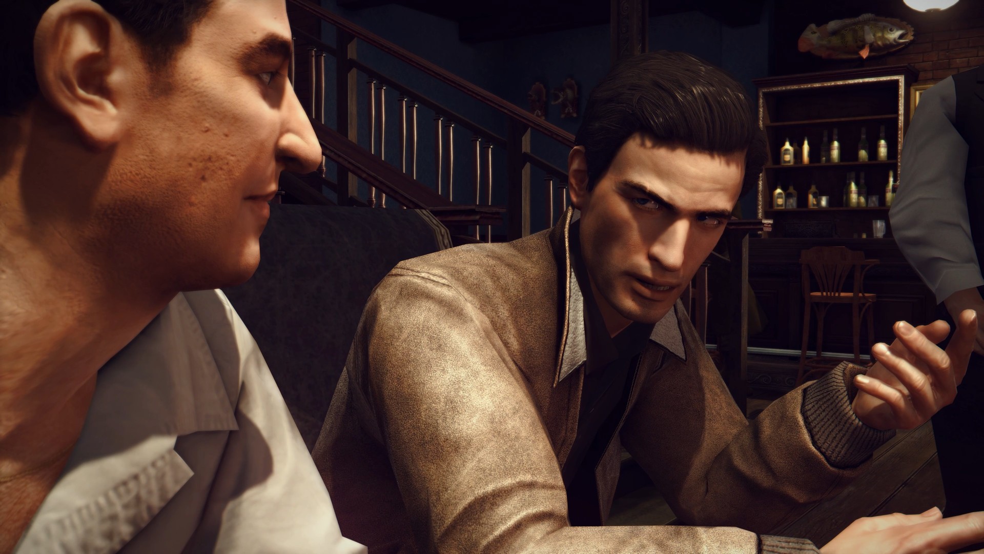 Vito and a companion talk inside a bar.