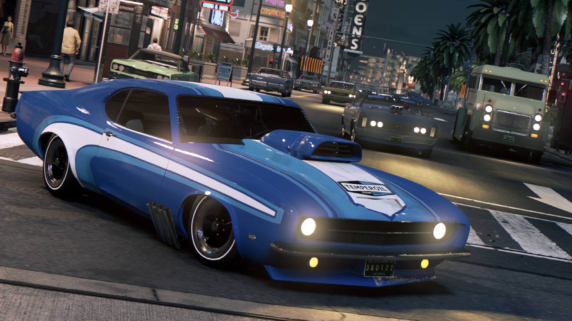 A blue muscle car drives through a city street.