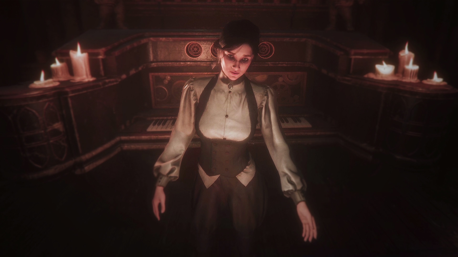 A woman stands among candles in a dim interior.