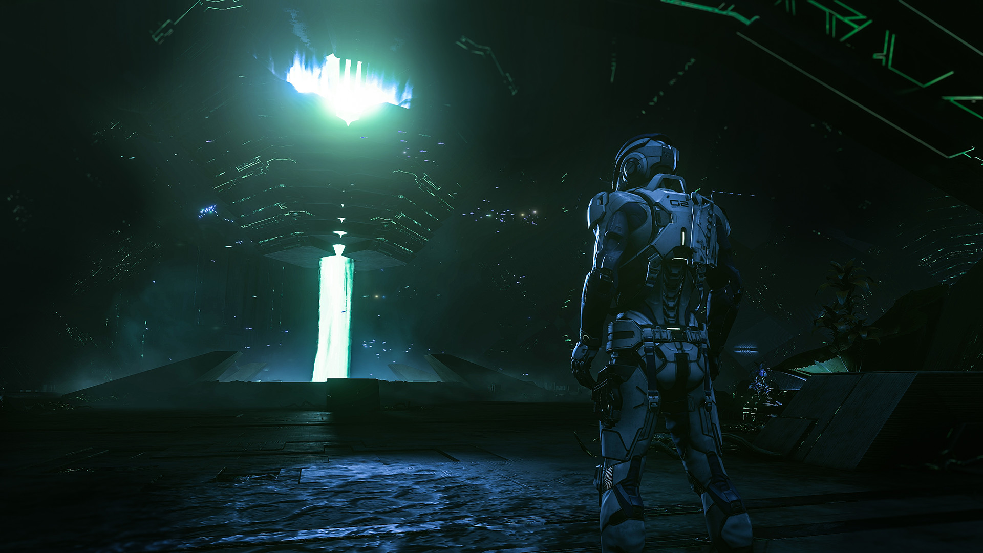An explorer approaches a glowing alien structure.