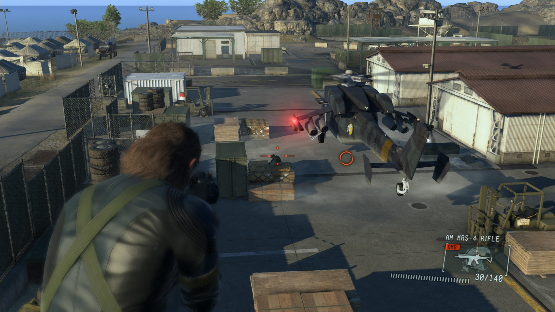 Snake faces a helicopter inside a military base.