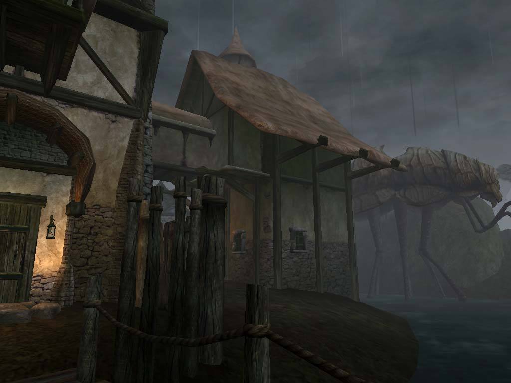 Weathered houses stand along a misty settlement street.