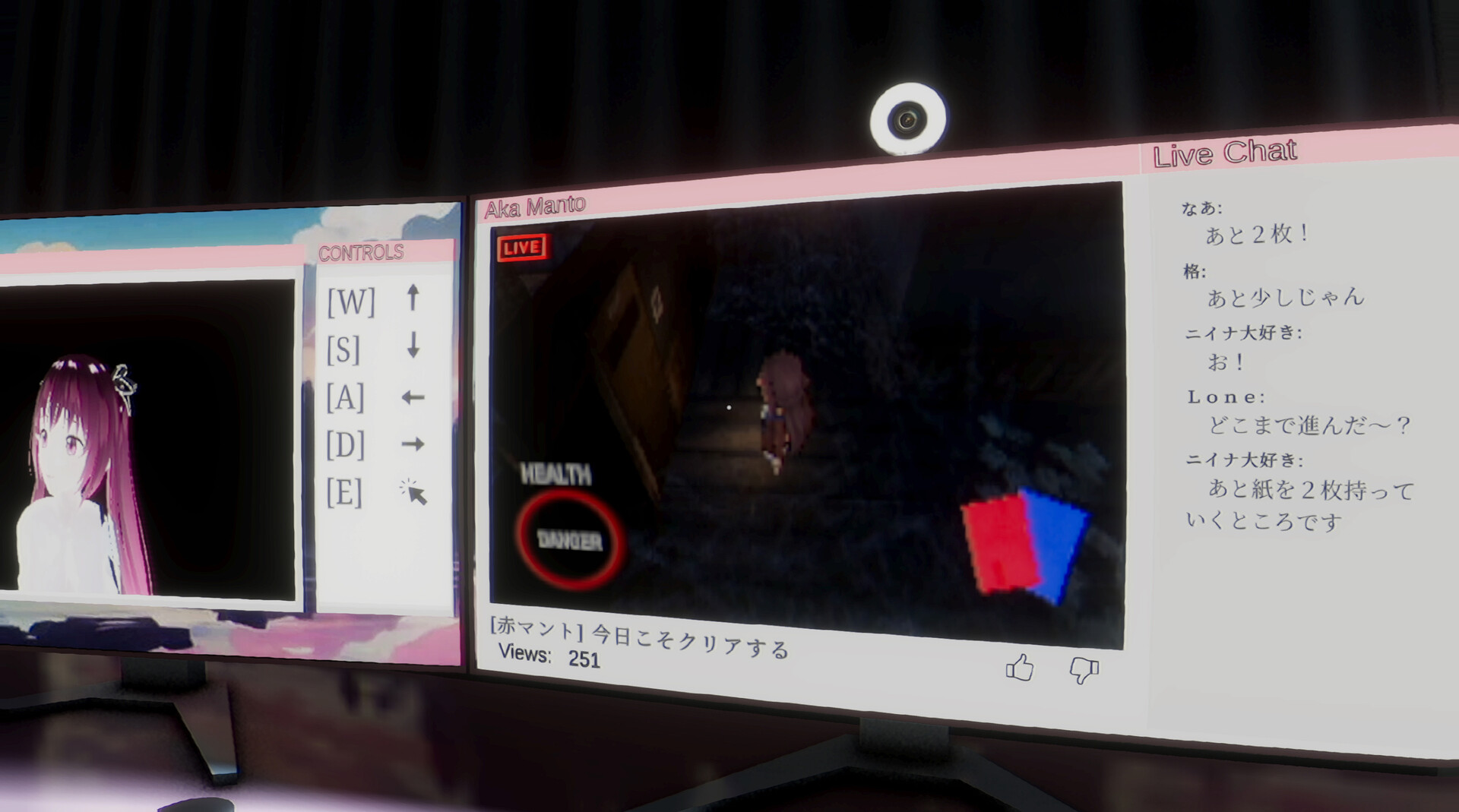A livestream of a horror game and its chat fills two computer monitors.