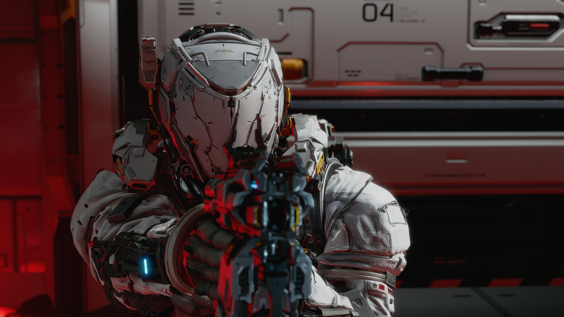 An armored figure aims a weapon inside a red-lit facility.