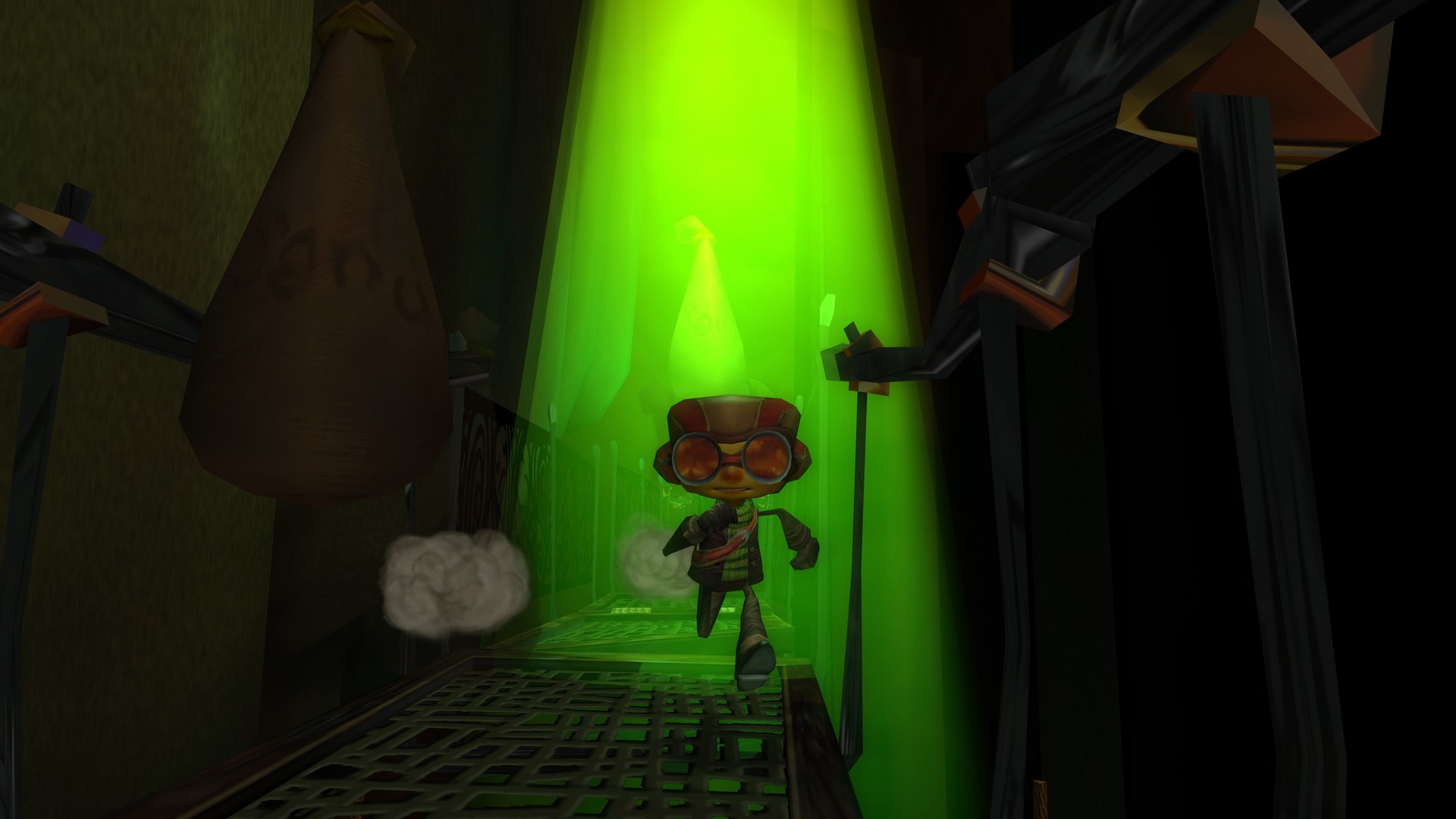 Raz walks toward a bright green light inside a dark passage.