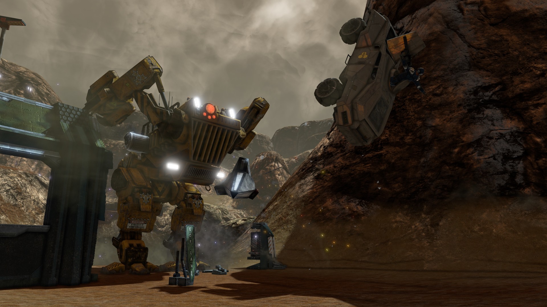 A vehicle crashes into a rocky slope near an industrial structure.