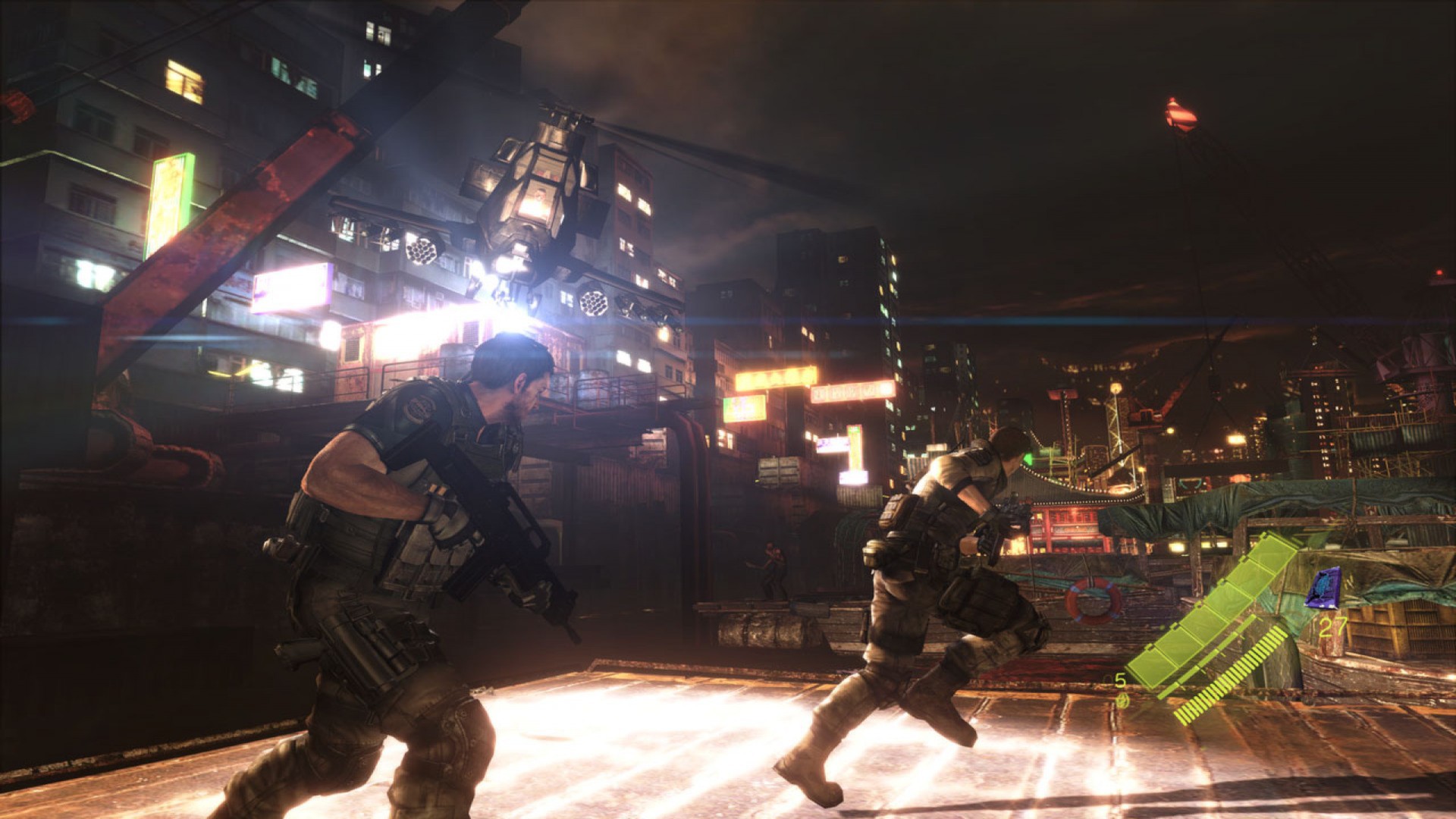 Armed operatives move across a city street at night.