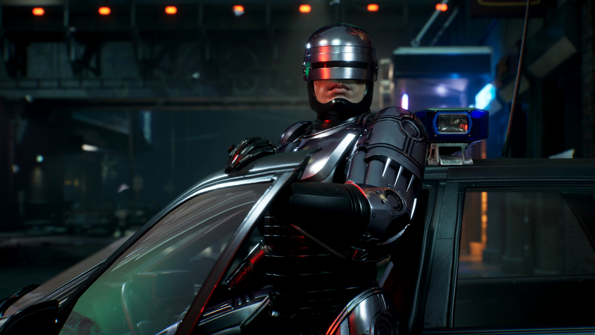 RoboCop leans against a car at night.