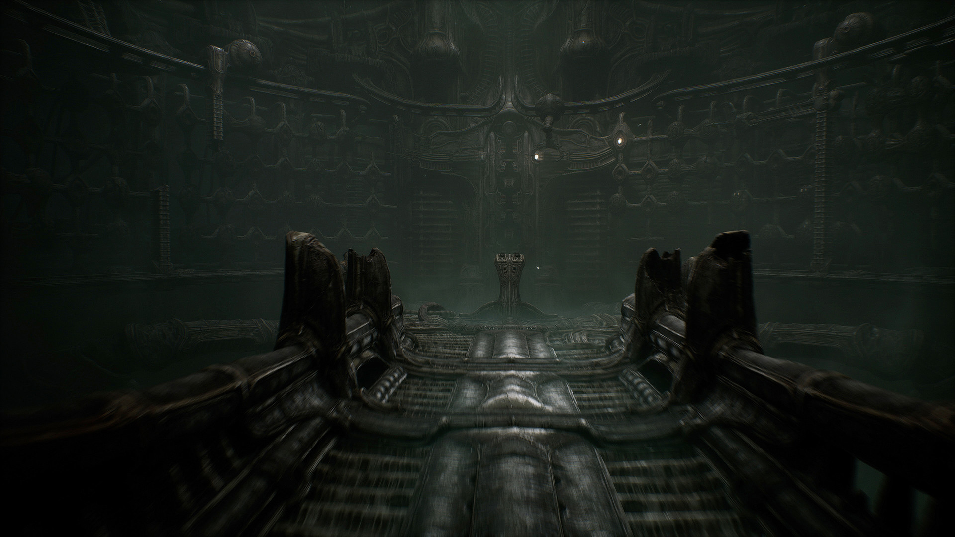 A dark biomechanical chamber contains an intricate floor mechanism.