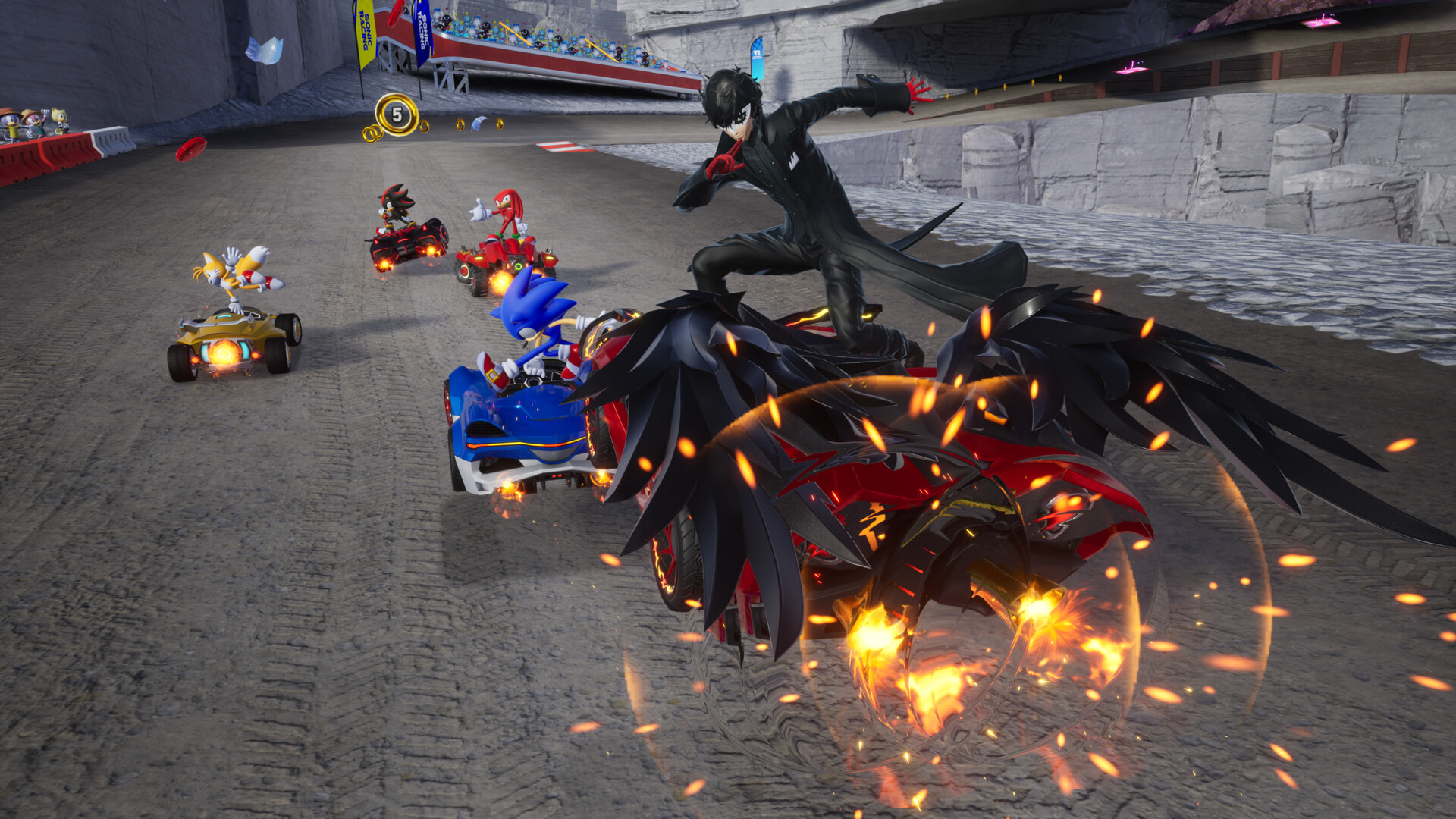 Sonic and other racers crowd a bend as Joker leaps above his vehicle.