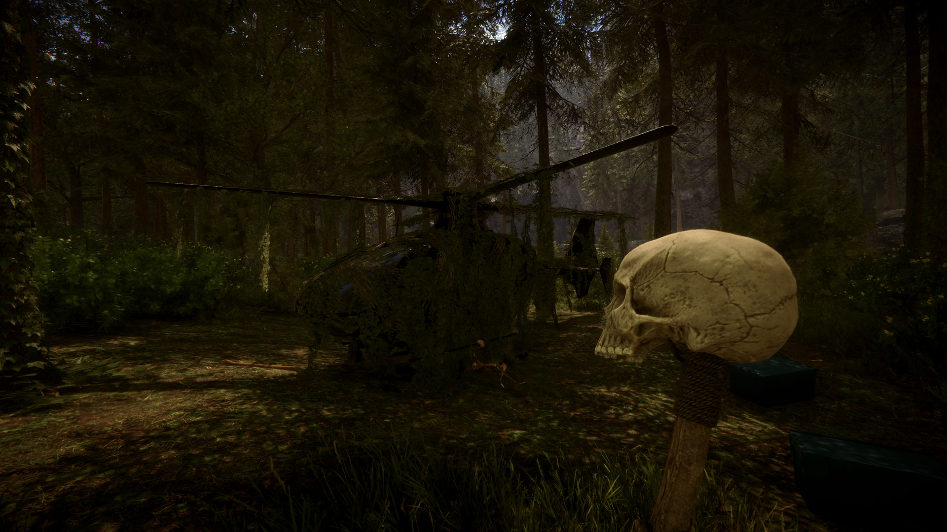 A skull-topped tool stands before a damaged helicopter in the forest.