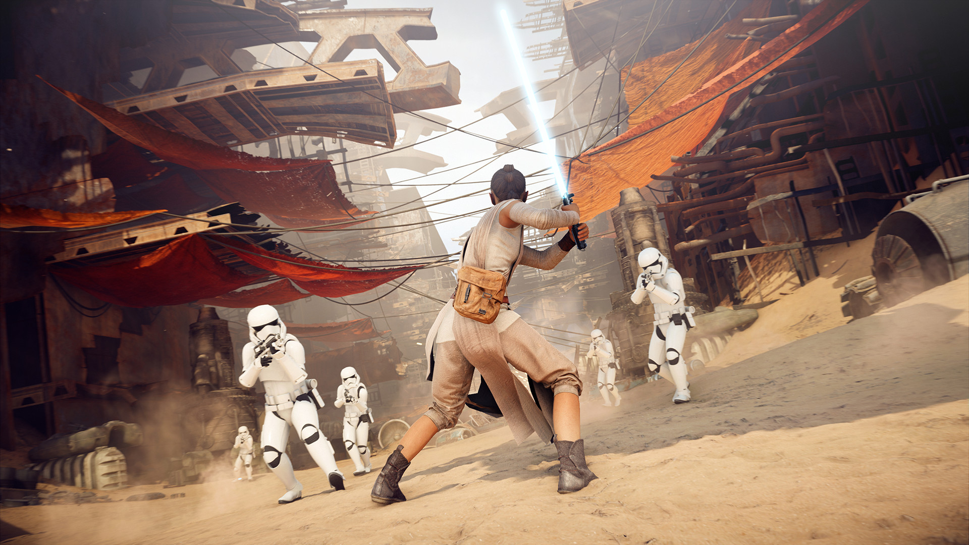 Rey fights stormtroopers with a lightsaber in a desert settlement.