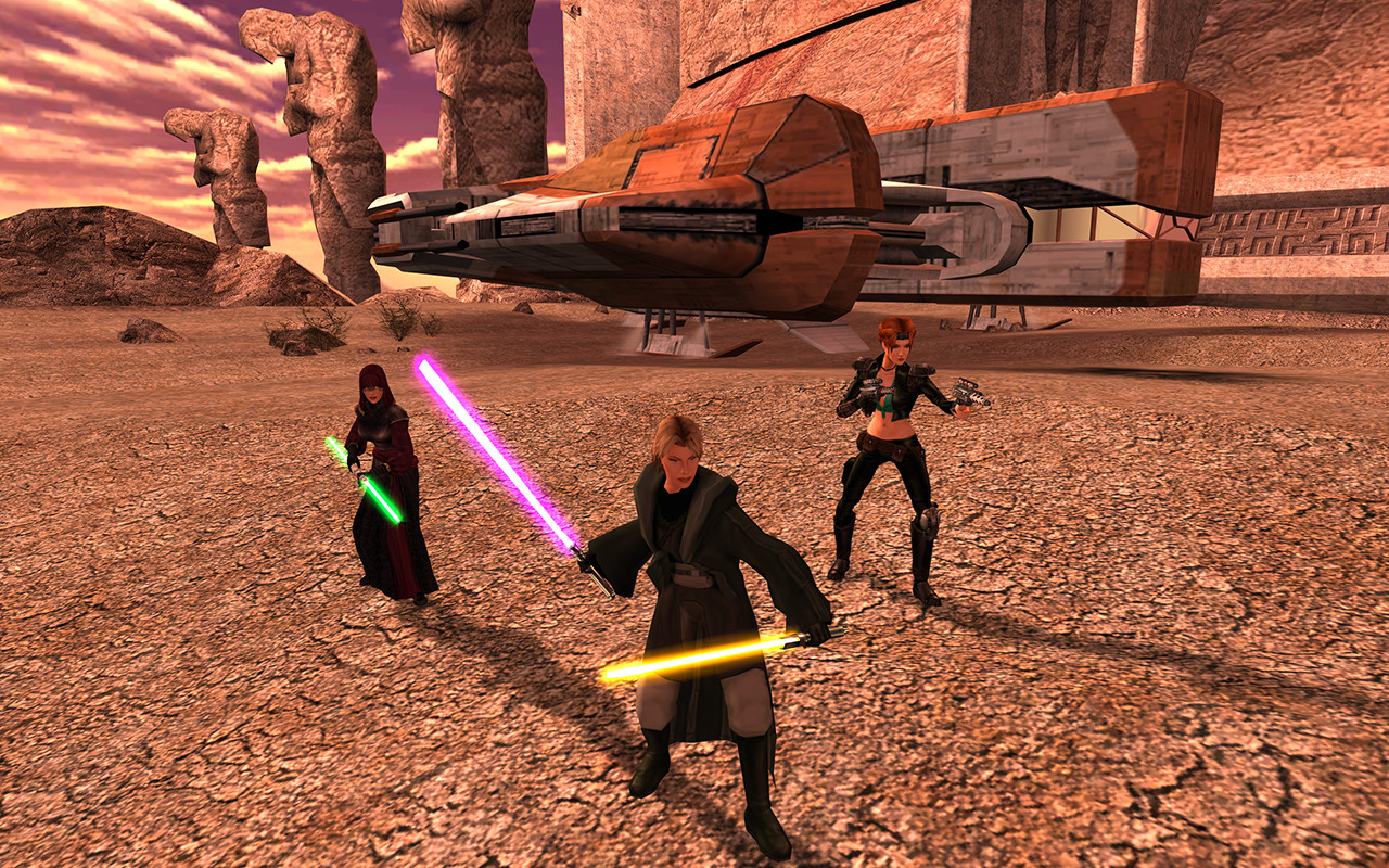 Three lightsaber wielders stand in a desert near a landed ship.
