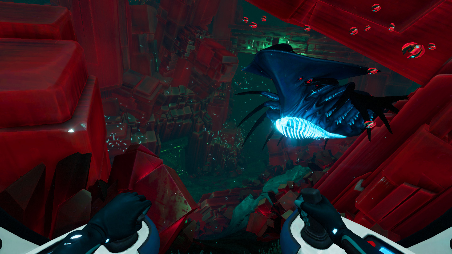 A large creature passes through a red-lit underwater cavern.