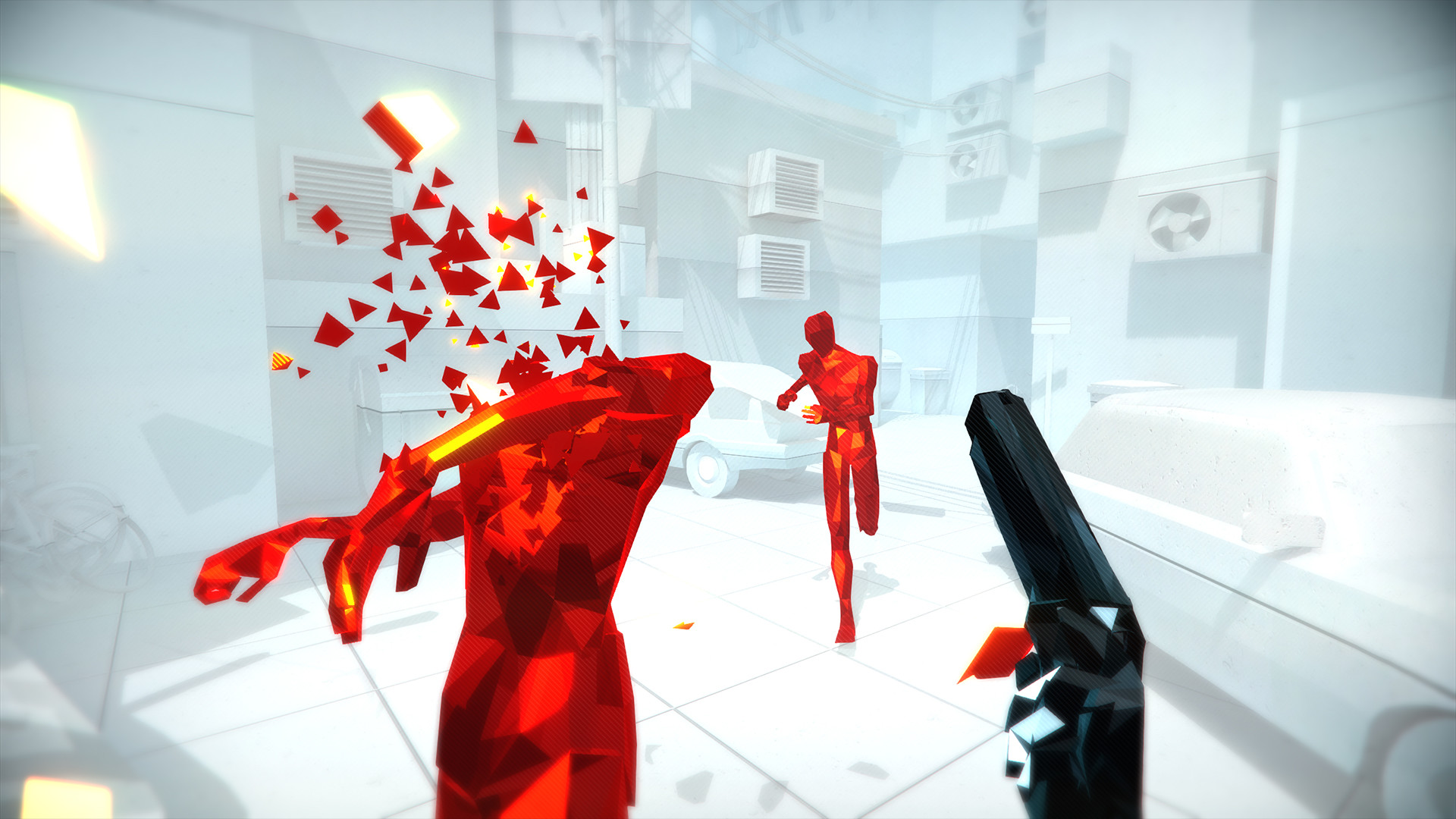 A first-person shot shatters a red enemy in a white room.